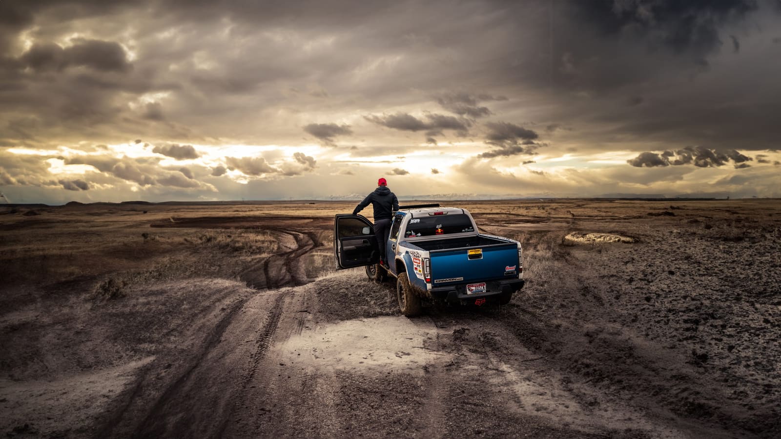 Truck at an overlook under a storm sky