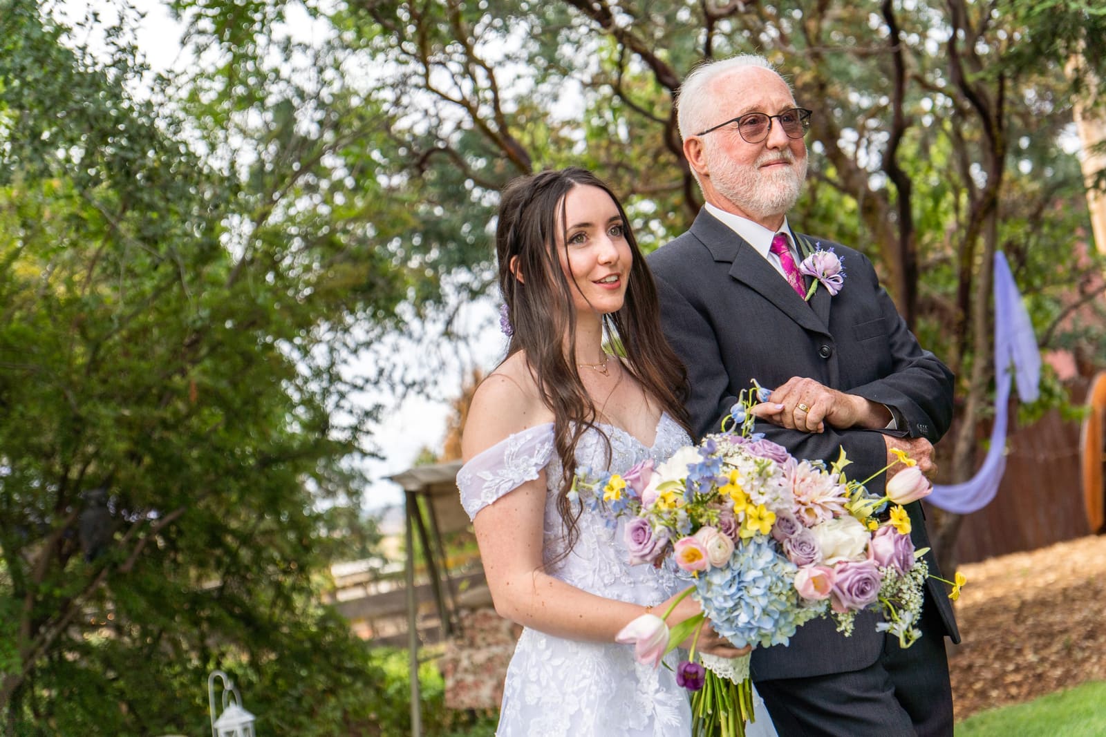 Bride walking arm in arm with her father